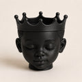 Afrocentric royal crown planter with a peaceful face and crown-shaped rim