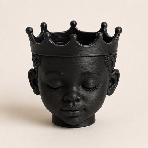 Afrocentric royal crown planter with a peaceful face and crown-shaped rim