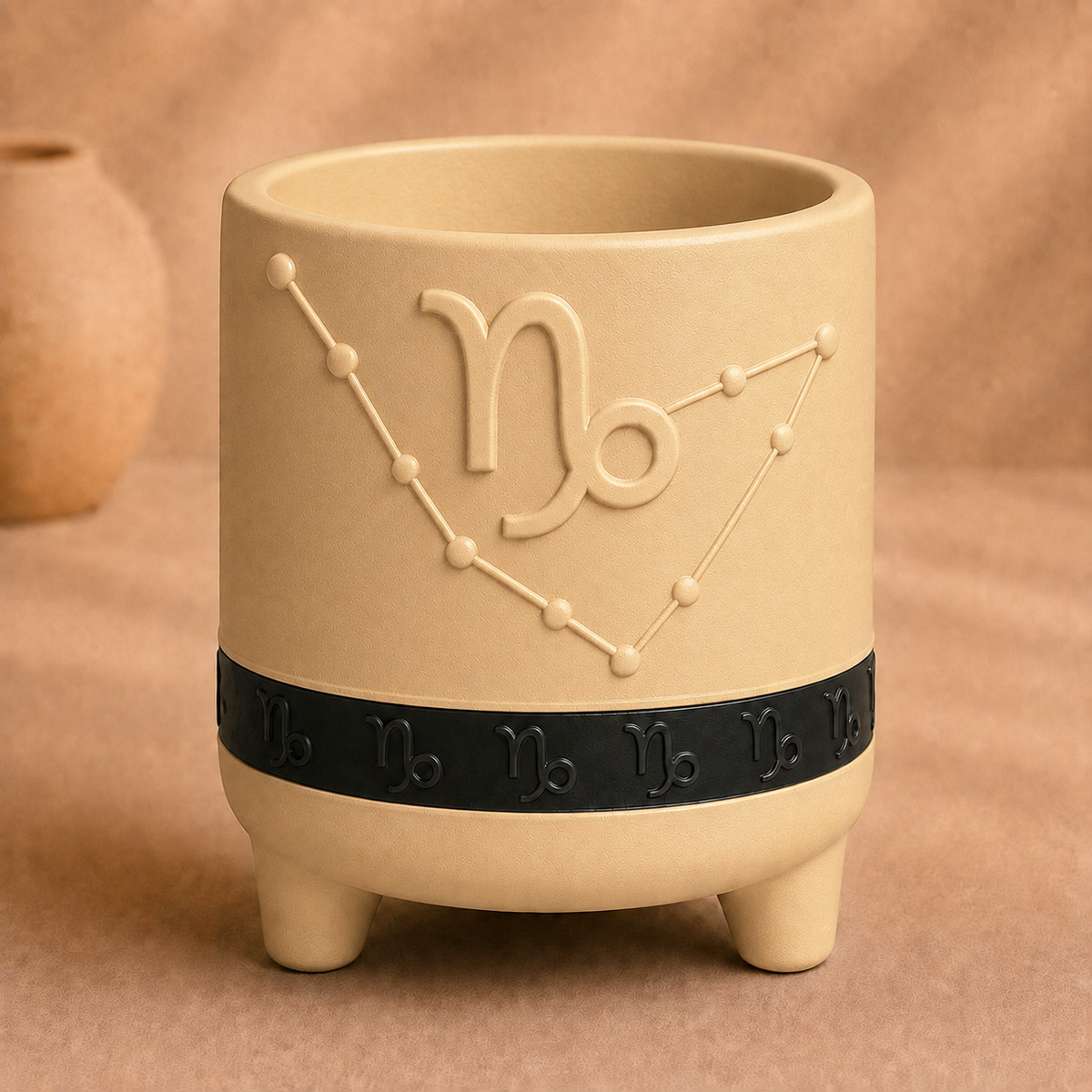 Warm beige Capricorn zodiac planter with raised Capricorn symbol, constellation, black zodiac band and footed base