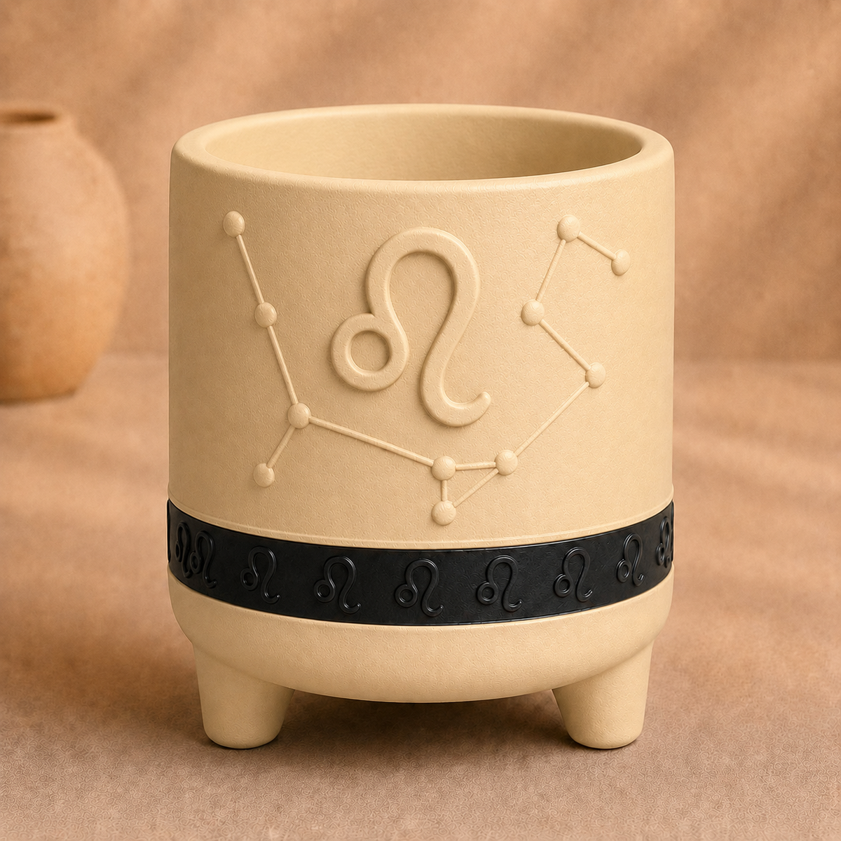 Warm beige Leo zodiac planter with raised Leo symbol, constellation, black zodiac band and footed base